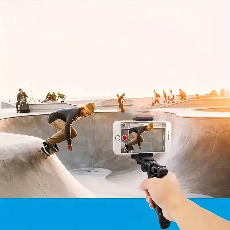 Person skateboarding in a bowl with a smartphone camera recording the action.